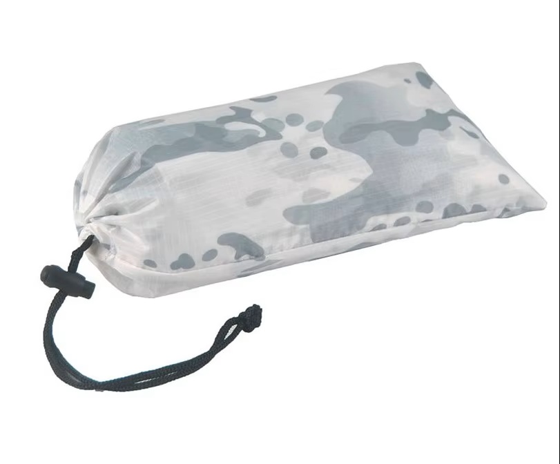 Military poncho design features including hood snaps and backpack compatibility