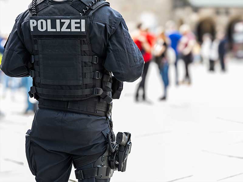 German police officer wearing a tactical vest for public security patrol.