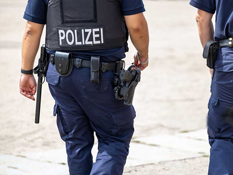Police officers wearing tactical vests during public security duty.