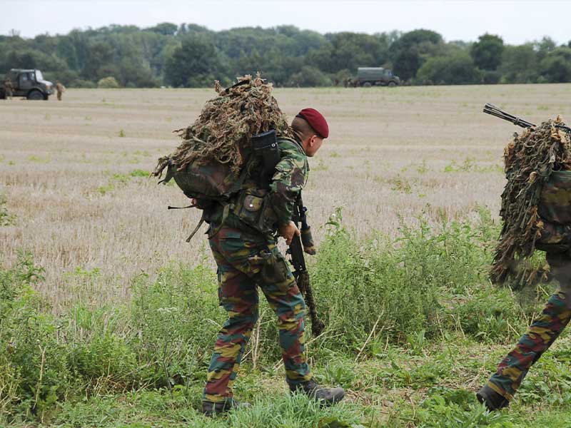 Soldiers wearing camouflage gear during field tactical training