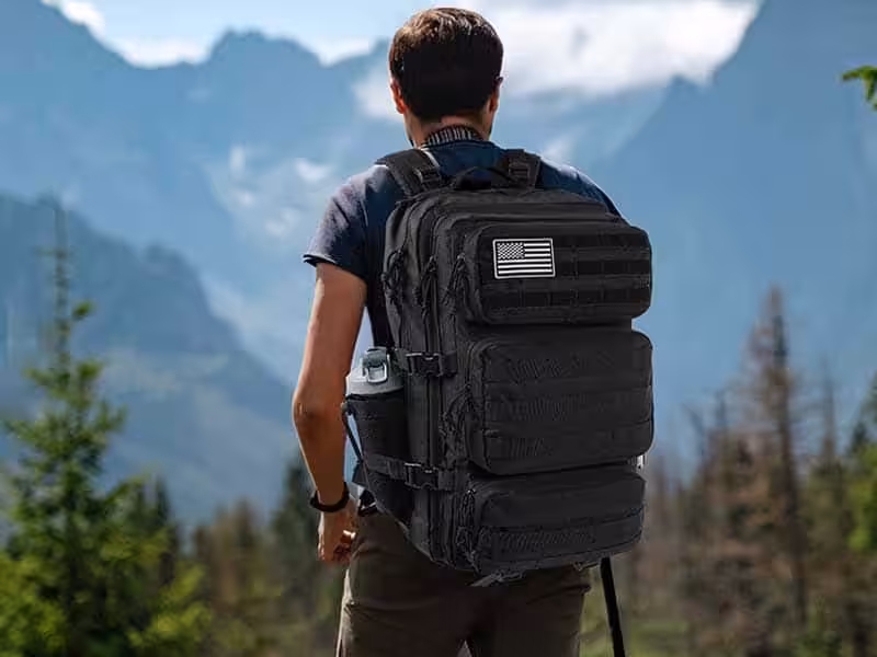 A man outdoors carrying a backpack.