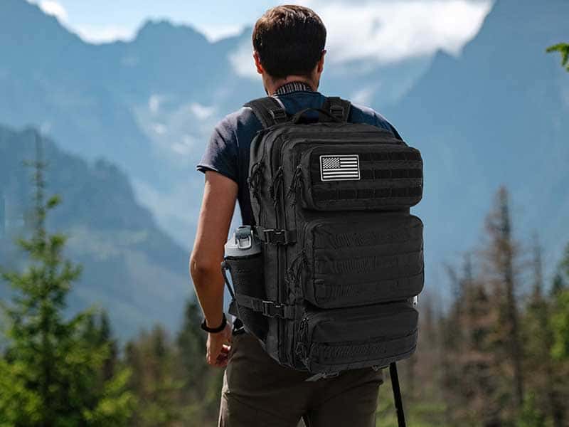 A man outdoors carrying a backpack.