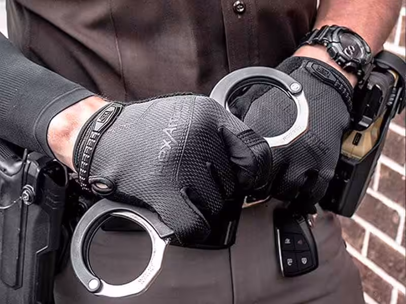 A person holding handcuffs.