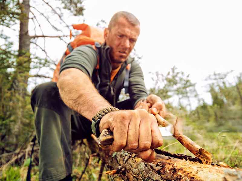 Survival gear in wilderness with tactical tools for outdoor emergency situations