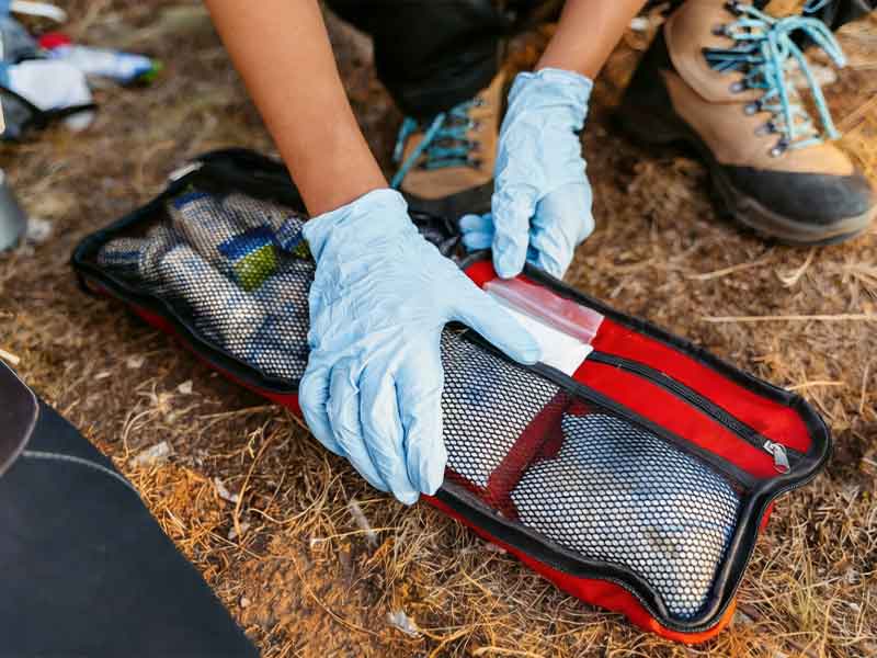 First aid survival kit with medical supplies for outdoor rescue and emergency response