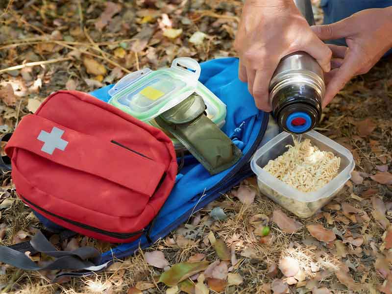Outdoor survival kit with first aid bag, emergency supplies and camping equipment for hiking