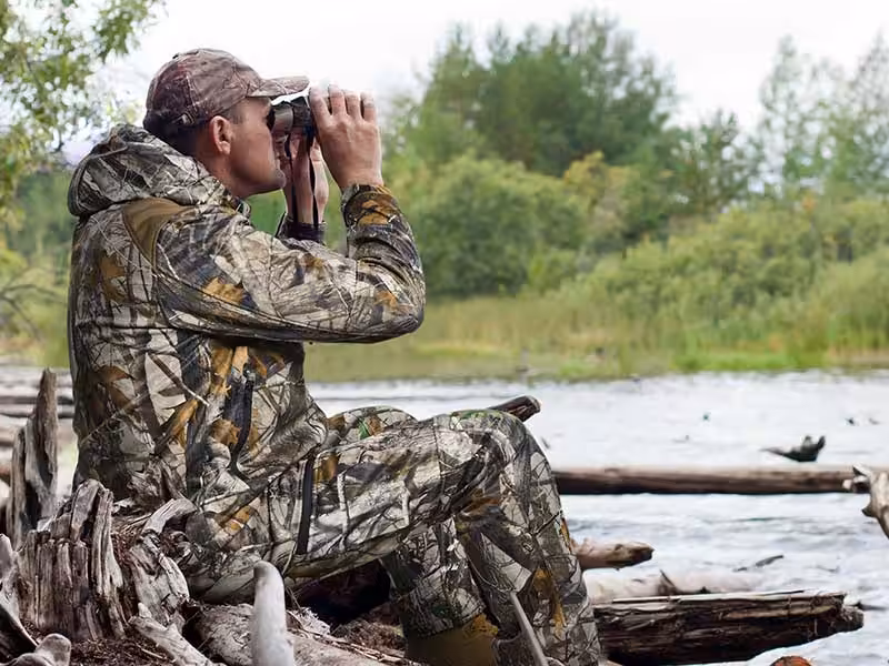 A soldier holding binoculars