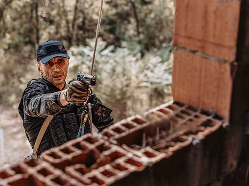 A soldier rappelling down.