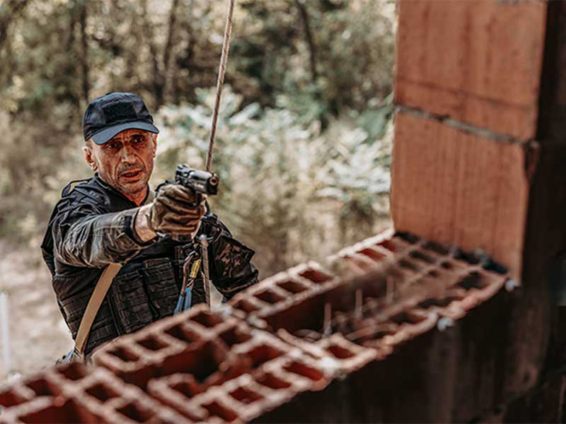 A soldier rappelling down.