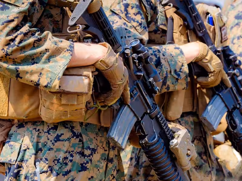 Several soldiers wearing tactical gloves