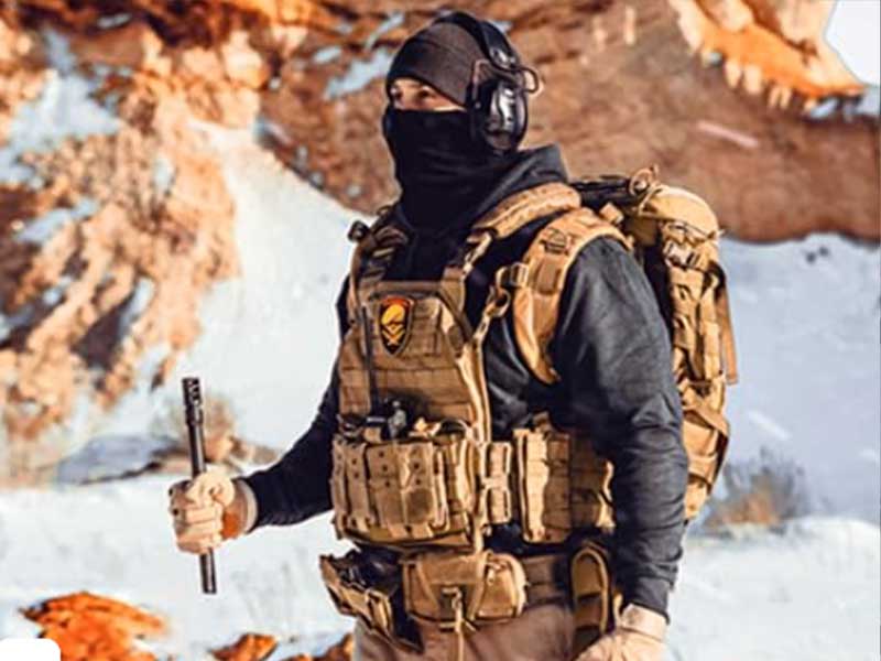 A soldier carrying a bulletproof vest.