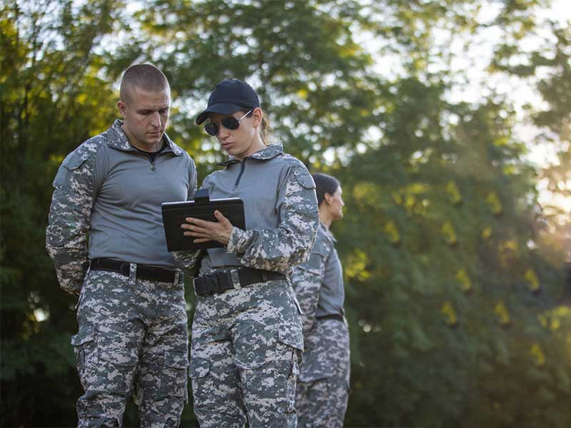 The male and female soldiers were discussing...